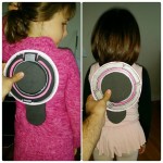 Test fitting of the back pieces of the girls' Tron suits. Battery packs for the EL wire will live in the disc's dock. Discs will attach to the dock with magnets.