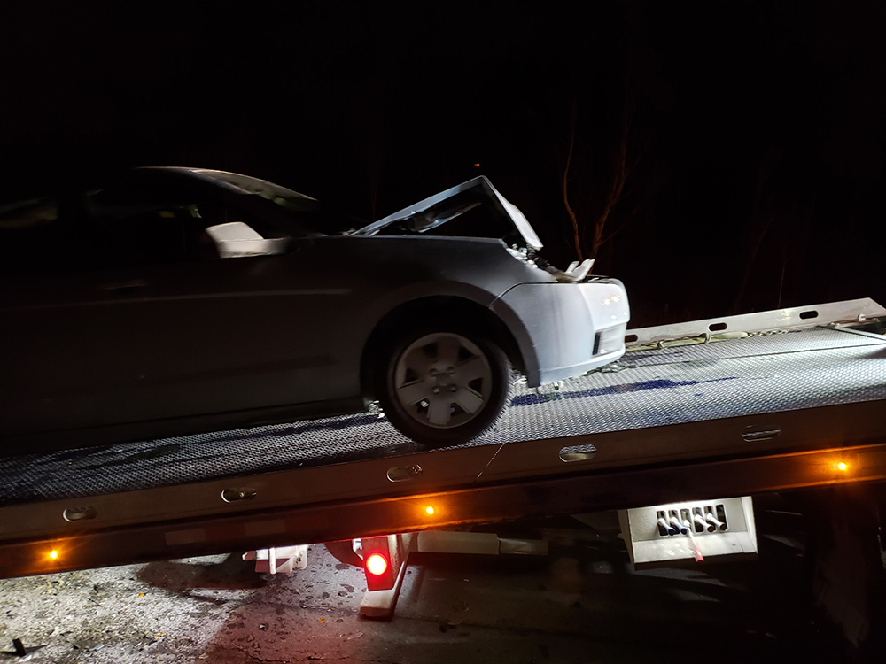 Wrecked car on tow truck