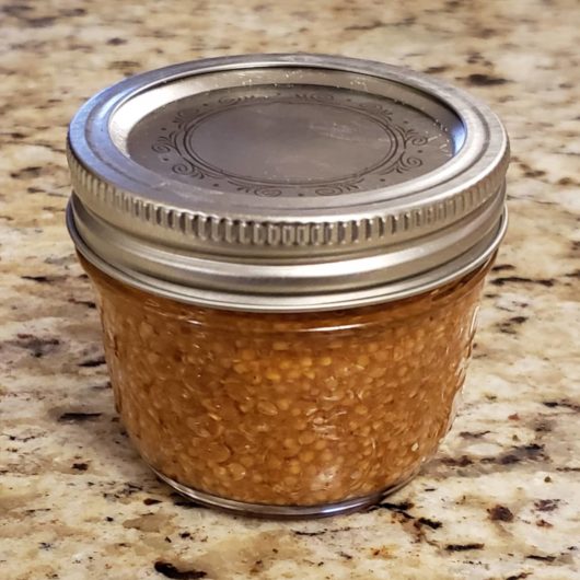Grainy maple sriracha mustard in a jar